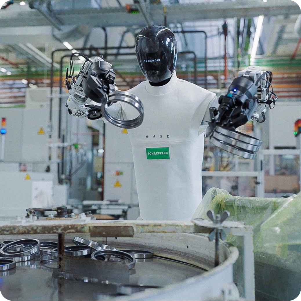 Humanoid robot picking metallic bearing rings at a Schaeffler site