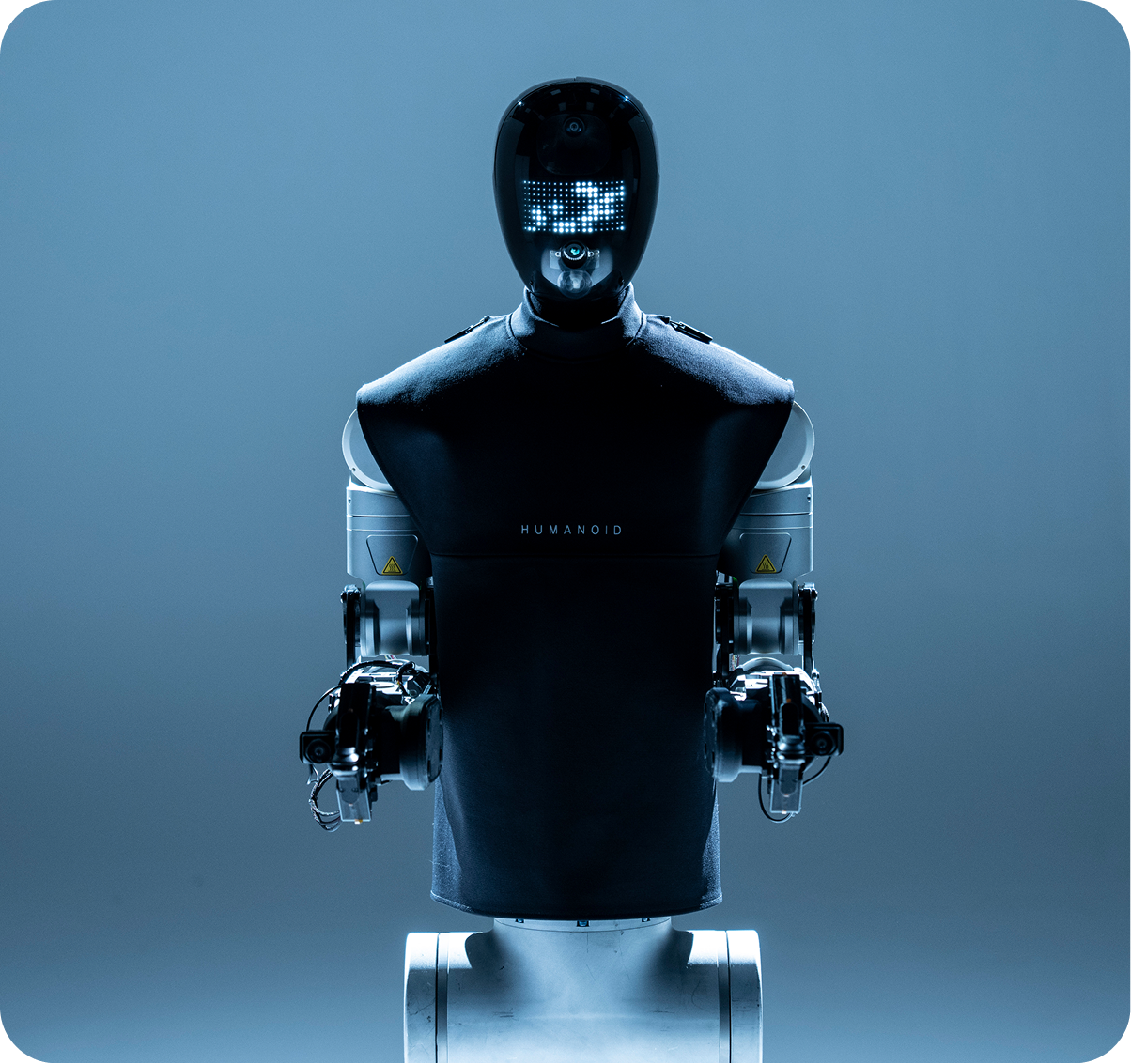 Humanoid robot torso on a blue studio background
